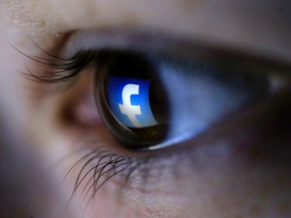 A picture illustration shows a Facebook logo reflected in a person's eye, in Zenica, March