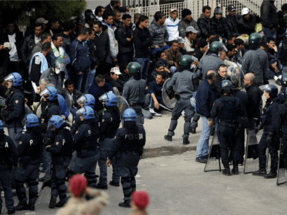 Police intervene to restore order in a temporary staying center, on the Italian island of