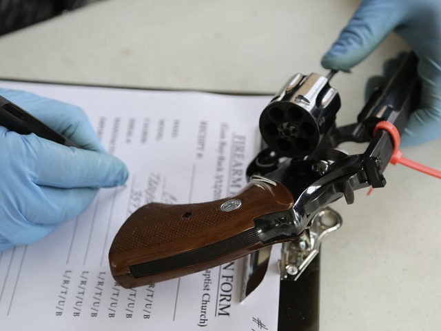 A Miami detective registers a Colt .357 Magnum than was turned in during a gun buyback program held at the Jordan Grove Missionary Baptist Church, Saturday, March 12, 2016, in Miami. The event was organized by Rev. Jerome Starling in response to continuing gun violence in the city. Over 100 …