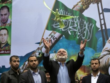 Gaza Hamas leader Ismail Haniya releases a dove during a rally of Hamas supporters to commemorate the 27th anniversary of the Islamist movements creation and to ask for the reconstruction of the Gaza Strip on December 12, 2014 in Jabalia refugee camp in the northern Gaza Strip.
