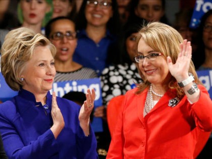 Democratic presidential candidate Hillary Clinton, left, applauds after former Arizona congresswoman Gabrielle Giffords, right, spoke at a Women for Hillary event at the New York Hilton hotel in midtown Manhattan one day ahead of the New York primary, Monday, April 18, 2016, in New York. (AP Photo/Kathy Willens)