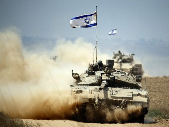 Israeli Merkava tanks roll near the border between Israel and the Gaza Strip as they return from the Hamas-controlled Palestinian coastal enclave on August 5, 2014, after Israel announced that all of its troops had withdrawn from Gaza.