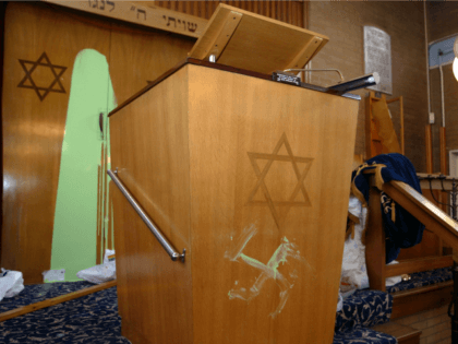 A swastika is daubed beneath the Star of David on a preaching lectern April 30, 2002 at Fi