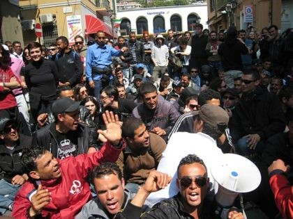 Around 60 mainly Tunisian migrants and a group of French and Italian activists demonstrate in front of the train station of the Italian border town of Ventimiglia after France cancelled trains due to cross the border to thwart migration demonstrations.