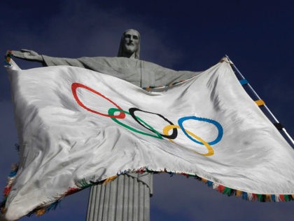 The Olympic Flag flies in front of ''Christ the Redeemer'' statue during a blessing ceremo