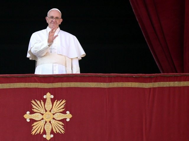 Pope Francis waves to the faithful as he delivers his 'Urbi et Orbi' blessing message from the central balcony of St Peter's Basilica on December 25, 2015 in Vatican City, Vatican.