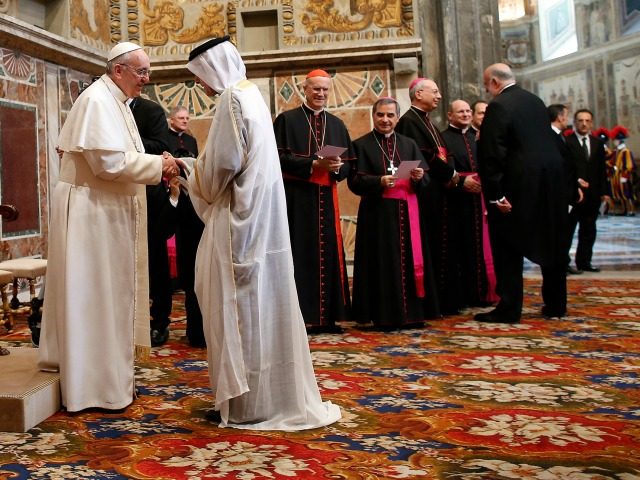 Pope Francis (L) greets a foreign diplomat during an audience with the diplomatic corps at the Vatican on March 22, 2013.