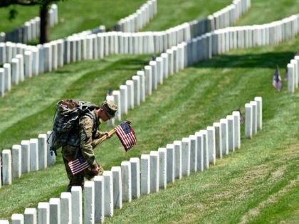 Members of the Old Guard place flags in front of every headstone at Arlington National Cemetery in Arlington, Va., Thursday, May 26, 2016. Soldiers were to place nearly a quarter of a million U.S. flags at the cemetery as part of a Memorial Day tradition. (AP Photo/Susan Walsh)