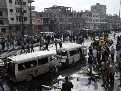 Syrians gather at the site of a double car bomb attack in the Al-Zahraa neighbourhood of the central Syrian city of Homs on February 21, 2016.