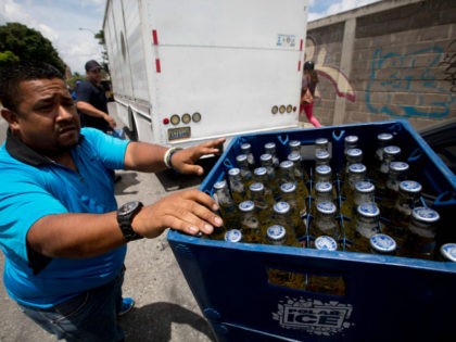 In this Friday, July 31, 2015, a Polar beer vendor makes his last weekend delivery to a li