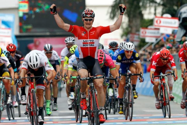 German cyclist Andre Greipel (C) raises his arms in victory as he crosses the finish line