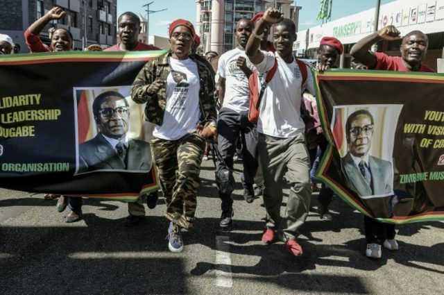 Supporters of Zimbabwean President Robert Mugabe march through Harare during a pro-regime