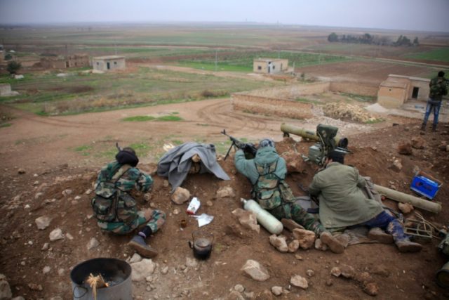Syrian pro-government fighters hold a position near the village of Al-Najjarah, east of th