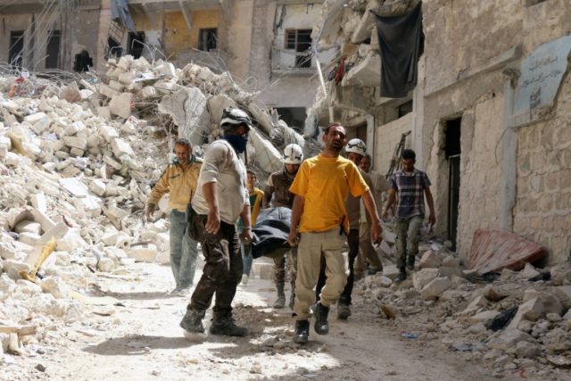 Syrian Civil Defence workers evacuate a body following a regime air strike on May 17, 2016