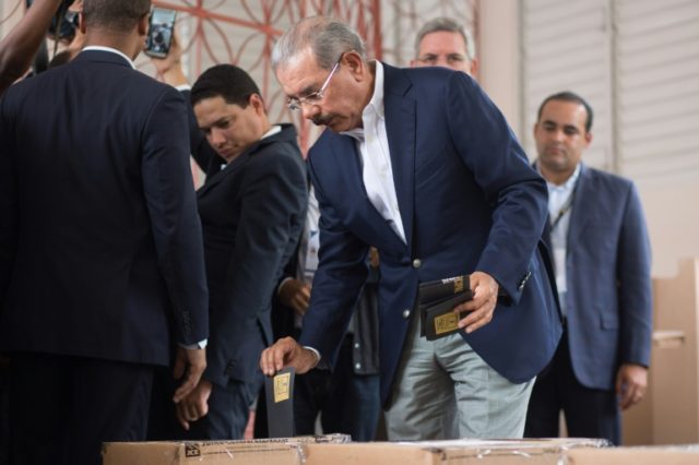 Standing for re-election, Dominican President Danilo Medina casts his vote at a polling st