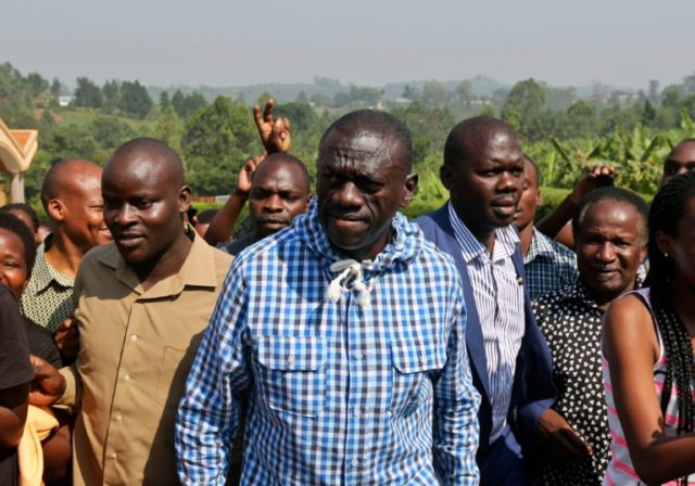 Uganda opposition leader Kizza Besigye arrives at a polling station to vote in his home to