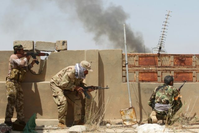 Iraqi pro-government fighters hold position in al-Shahabi village, east of Fallujah, on Ma