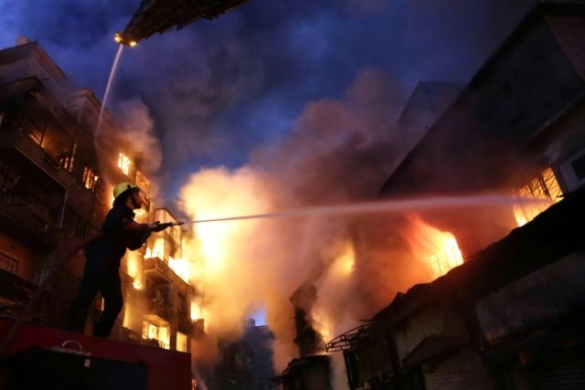 Egyptian firefighters tackle a blaze in downtown Cairo on May 9, 2016