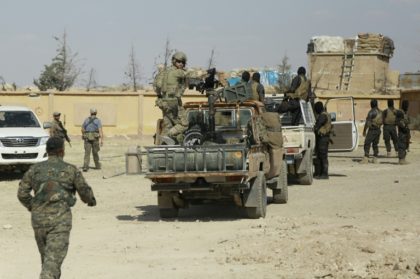 Syrian Democratic forces and an armed man in uniform identified as US special operations f
