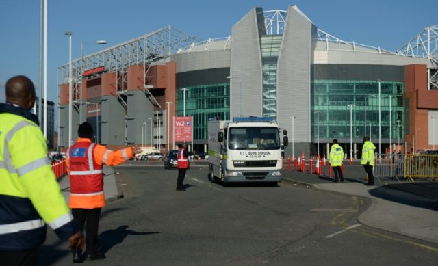 Event staff guide a British Army Bomb Disposal Unit truck as it leaves Old Trafford stadiu