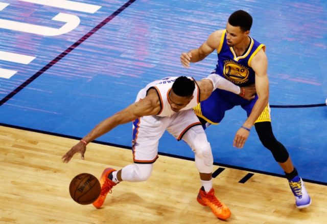 Russell Westbrook of the Oklahoma City Thunder drives against Stephen Curry of the Golden