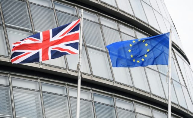 The British flag (L) and the European Union flag fly outside City Hall in central London o