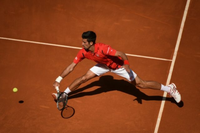 Serbian tennis player Novak Djokovic returns a ball to Croatian tennis player Borna Coric