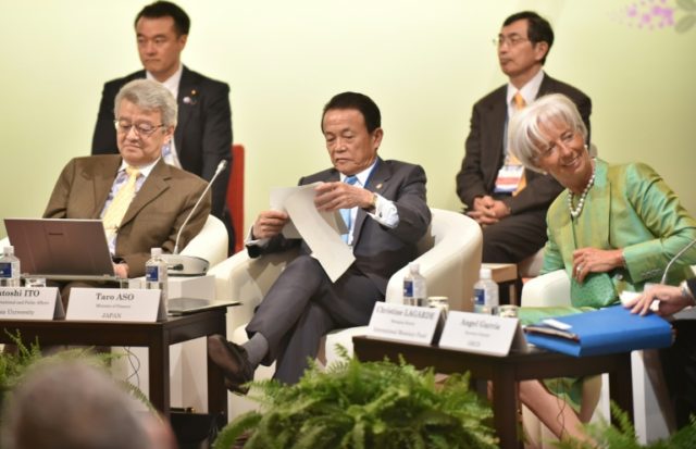 Japanese Finance Minister Taro Aso (C) and International Monetary Fund Managing Director C