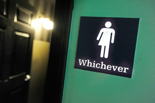 A gender neutral sign is posted outside a bathroom on May 11, 2016 in Durham, North Carolina