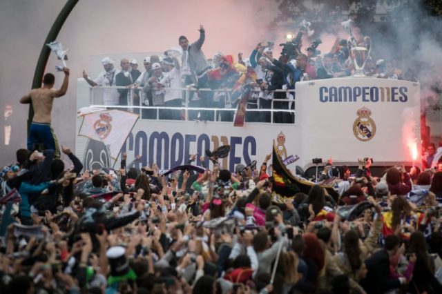 Real Madrid supporters celebrate as the victorious Champions League side arrive at Plaza C