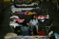 A young girl sits on a cot at a makeshift evacuee center in Lac la Biche, Alberta after fleeing forest fires north of Fort McMurray A young girl sits on a cot at a makeshift evacuee center in Lac la Biche, Alberta after fleeing forest fires north of Fort McMurray