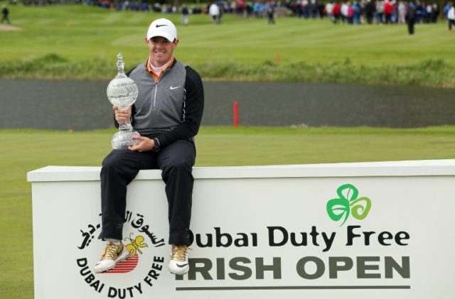 Northern Ireland's Rory McIlroy, poses with the trophy after his three shot victory in the