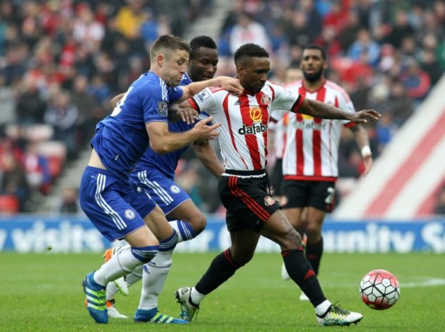 Sunderland's Jermain Defoe fights for the ball with Chelsea's Gary Cahill (L) during their