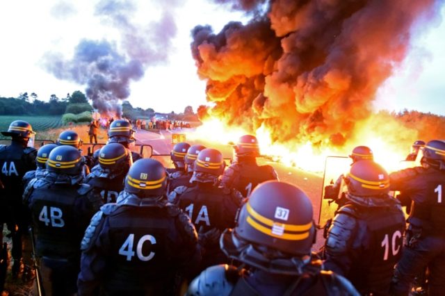 With a fifth of petrol stations in France running low, police moved in to break a blockade