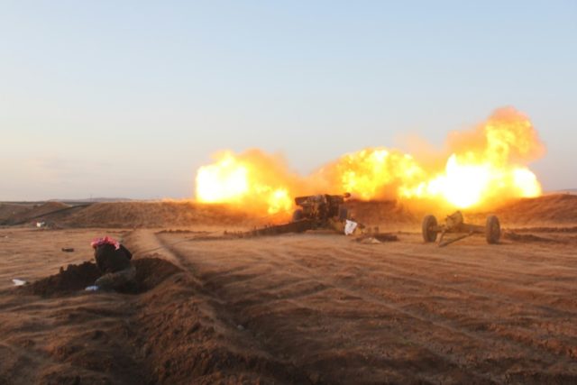 A rebel fighter from the Jaish al-Fatah (or Army of Conquest) brigades fires artillery dur