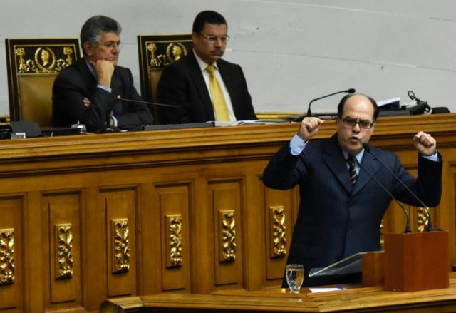 Venezuelan opposition deputy Julio Borges (R) delivers a speech during a special session a