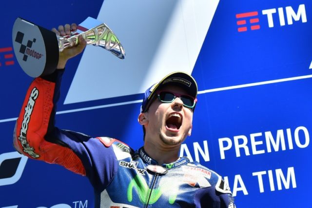 Spanish rider Jorge Lorenzo celebrates on the podium after winning the Italian Moto Grand