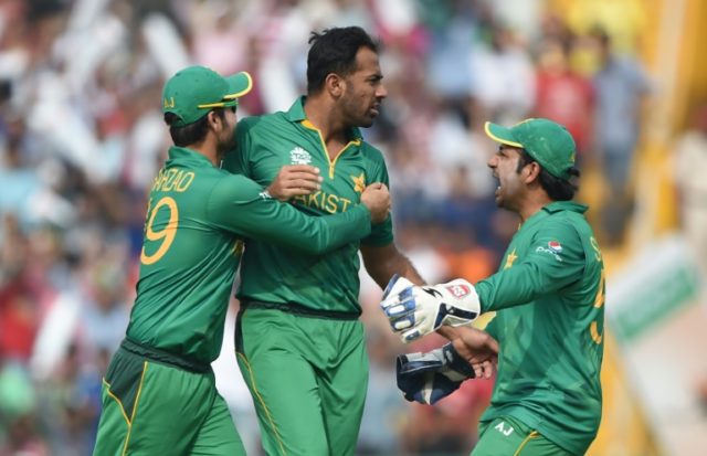 Pakistan's Wahab Riaz (C)celebrates with teammates Ahmed Shehzad (L) and wicketkeeper Sarf