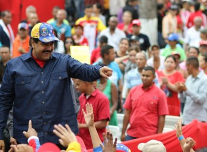 Venezuelan President Nicolas Maduro(L) greets supporters during a rally at the Miraflores presidential palace in Caracas