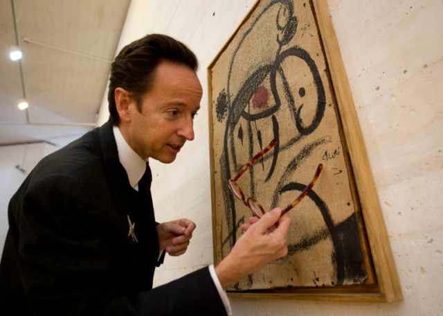Joan Punyet Miro, grandson of Spanish artist Joan Miro, looks at a painting during the exh