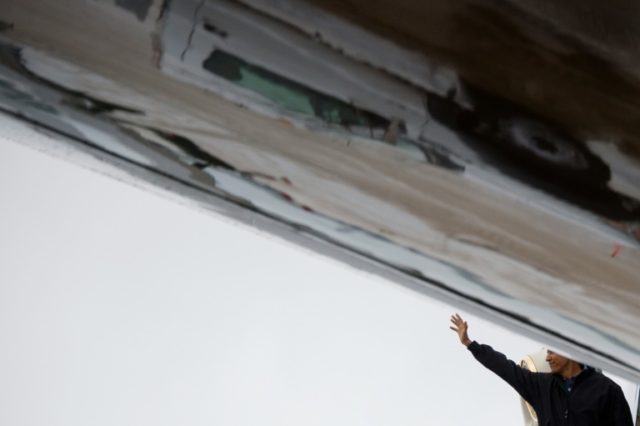 US President Barack Obama waves as he boards Air Force One at Joint Base Andrews, Maryland