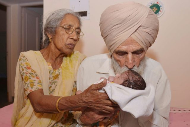 Indian father Mohinder Singh Gill, 79, and his wife Daljinder Kaur, 70, hold their newborn