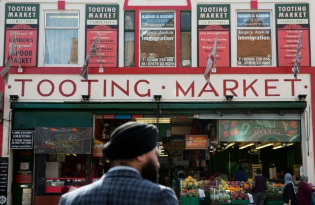 A man waits to cross a road in Tooting, south London -- the constituency of Sadiq Khan --