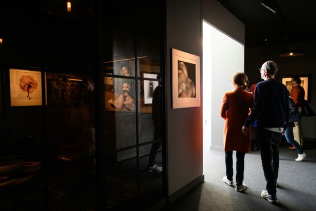 Visitors view work on display in the gallery areas at the "Photo London 2016" event at Som