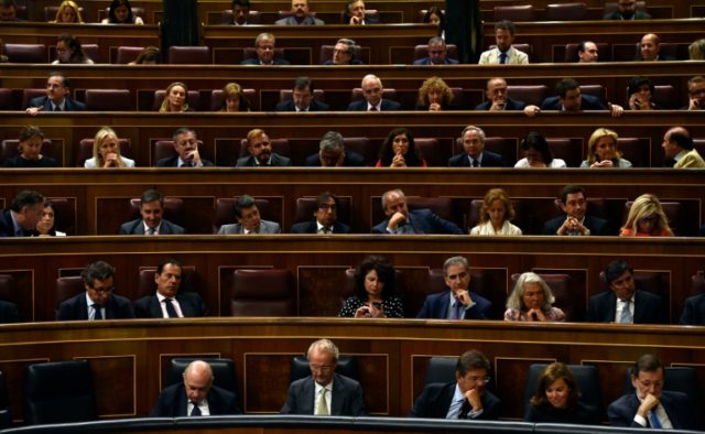 Government members and members of parliament listen to the speech of the Spain's Treasury