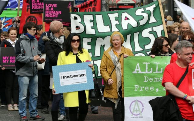 Pro-choice campaigners take part in a demonstration through Belfast city centre on April 3