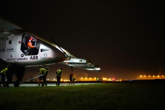 Solar Impulse 2 workers tow the experimental solar-powered aircraft to the runway in Tulsa