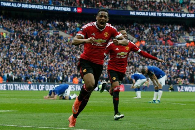 Manchester United striker Anthony Martial (C) celebrates after scoring during the English