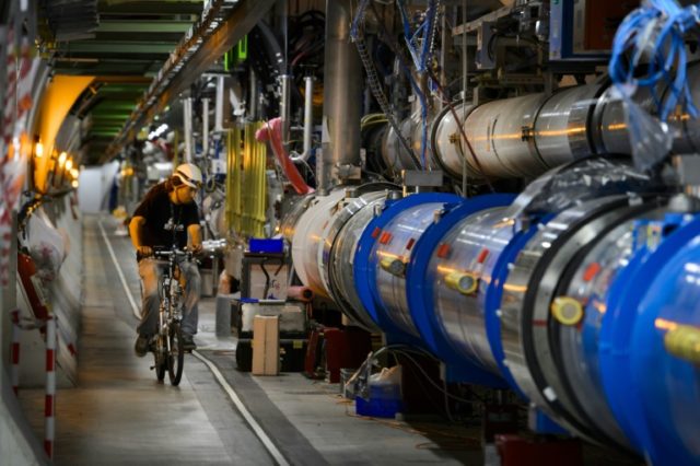 A worker rides his bicycle in a tunnel of the European Organisation for Nuclear Research (