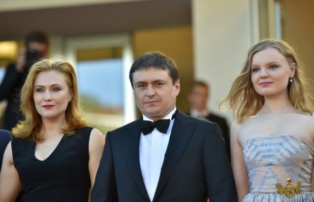 Romanian director Cristian Mungiu (C) arrives for the screening of his film "Graduation" a